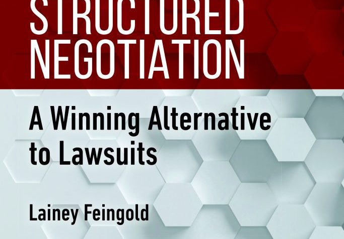 The words Structured Negotiation are printed in large white text on a vibrant red band (color contrast checked for readability). The subtitle appears below in black text, with my name under that. The background of the cover is made up of three dimensional and shaded white and gray hexagons. A hexagon is a six-sided shape. There is text on two of the hexagons on the bottom left corner. One hexagon says ABA Section of Dispute Resolution. The other says ABA Commission on Disability Rights.