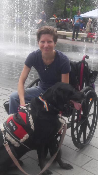 Amanda Siebe, a white woman in a wheelchair and her service dog, Dobby.