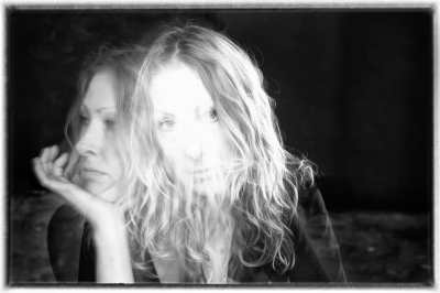 Black and white double exposure head-shot of Anna Berry, one in which she is looking forward, and one in profile.