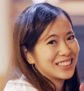 Taiwanese American female with long brown hair and dark brown eyes smiling