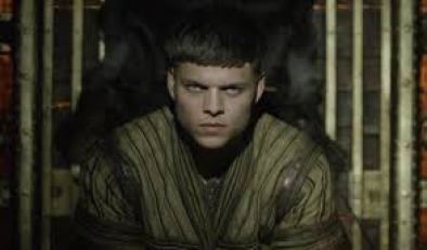 Image description: screenshot from an episode of Vikings, an original series on the History Channel. Ivar the Boneless is a young Viking warrior with short dark hair. He is staring intensely at the camera with menace. 