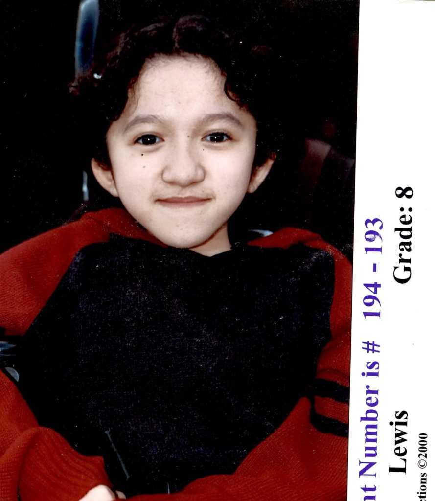 Photo of the author in 8th grade, the same age as the film's protagonist Meilin Lee. Sandy is wearing a dark sweater with red sleeves. She has dark curly wavy hair, dark brown eyes, and is smiling at the camera. The handlebars of her wheelchair can be seen in the background. Along the edges of the photo is the label Grade: 8