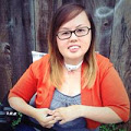 Asian American woman with blonde highlights. She is wearing glasses and is sitting in a wheelchair.