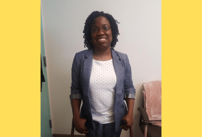 Graphic with a yellow background featuring a photo of a Black woman with curly natural, black hair and glasses in a blue chambray suit and white and blue polka dot top standing on crutches in an office.