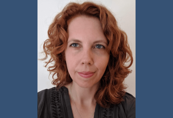 A graphic with a dark blue background and in the center is a photo of Jessica Murray, a middle-aged white woman, with curly red hair and a determined look on her face.