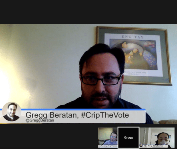 Screenshot of a Google hangout. A white man with short dark brown hair and a beard. He is wearing eyeglasses. There is a horizontal panel below him that reads, Gregg Beratan, #CripTheVote @GreggBeratan