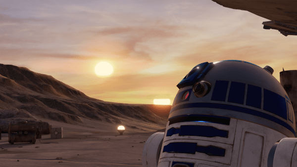 Illustration from a Lucasfilm Ltd ILMxLAB virtual reality experience, "Trials on Tatooine." The image shows in the character R2-D2 from the Star Wars universe in the lower-right side of the image in the foreground. R2-D2 is a droid with white and blue markings including a camera and several other tools and sensors on the upper part of its body. In the background is the Tatooine, a fictional desert planet from the Star Wars universe. The background shows several rocky formations, a pale sky with scattered clouds and two suns low to the horizon.